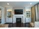 Cozy living room showcasing a fireplace with decorative tile, built-in shelving, and hardwood floors at 14193 Double Dutch Cir, Parker, CO 80134