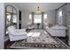 Bright and airy living room featuring elegant curtains, a patterned rug and cozy seating at 14193 Double Dutch Cir, Parker, CO 80134