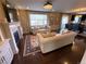Bright living area with a fireplace, hardwood floors, and a view into the dining space at 14193 Double Dutch Cir, Parker, CO 80134