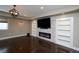 Comfortable living room with hardwood floors, a stone fireplace, and built-in shelving at 14193 Double Dutch Cir, Parker, CO 80134