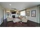Inviting living room with fireplace, built-in shelving, hardwood floors, and comfortable seating at 14193 Double Dutch Cir, Parker, CO 80134