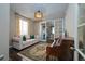 Living room displaying hardwood floors, neutral walls, sofa, piano and french doors at 14193 Double Dutch Cir, Parker, CO 80134