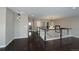 Spacious loft area featuring dark hardwood floors and white banisters, open concept at 14193 Double Dutch Cir, Parker, CO 80134