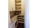 Walk-in pantry with granite countertop, custom shelving, and ample storage space at 14193 Double Dutch Cir, Parker, CO 80134