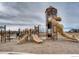 Community playground with multiple slides and play structures on a mulch surface at 14193 Double Dutch Cir, Parker, CO 80134