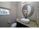 Powder room featuring granite countertop, vessel sink, modern faucet, and decorative window shade at 14193 Double Dutch Cir, Parker, CO 80134