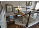 Staircase displaying wooden and white banisters with an overhead view of a chandelier lit dining area at 14193 Double Dutch Cir, Parker, CO 80134