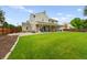 Expansive backyard featuring a lush green lawn, patio, and covered sitting area at 8896 W Prentice Ave, Littleton, CO 80123