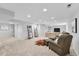 Finished basement features plush seating, television, and shelving at 8896 W Prentice Ave, Littleton, CO 80123