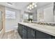 Bright bathroom featuring a double sink vanity, framed mirror, and glass shower at 8896 W Prentice Ave, Littleton, CO 80123