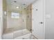 Bathroom featuring glass shower, white door, and tile at 8896 W Prentice Ave, Littleton, CO 80123