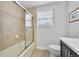 Bathroom featuring a shower with glass doors and a light-filled window at 8896 W Prentice Ave, Littleton, CO 80123