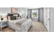 Cozy bedroom with a large window, neutral decor, and comfortable furnishings at 8896 W Prentice Ave, Littleton, CO 80123