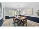 Dining room featuring a dark wood table and six chairs with a neutral colored rug at 8896 W Prentice Ave, Littleton, CO 80123