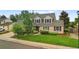 Beautifully landscaped front yard featuring a well-maintained lawn and attractive brick facade at 8896 W Prentice Ave, Littleton, CO 80123