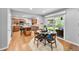 Bright kitchen with stainless steel appliances and hardwood floors, seamlessly connected to the dining area at 8896 W Prentice Ave, Littleton, CO 80123