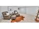 Cozy seating area featuring comfortable armchairs and soft neutral carpeting at 8896 W Prentice Ave, Littleton, CO 80123