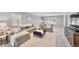 Comfortable living room featuring a large sofa and bright natural light at 8896 W Prentice Ave, Littleton, CO 80123