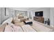 Inviting living room showcasing a comfortable sectional and modern entertainment center at 8896 W Prentice Ave, Littleton, CO 80123