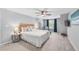 Bright main bedroom with ceiling fan, area rug, and a TV at 8896 W Prentice Ave, Littleton, CO 80123