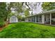 Spacious backyard showcasing a shed, a verdant lawn, and a sunroom at 2083 W Arbor Ave, Littleton, CO 80120