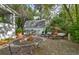 Outdoor patio with lounge chairs, gravel landscaping, fire pit and shed at 2083 W Arbor Ave, Littleton, CO 80120