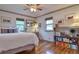 Bright bedroom featuring hardwood floors, neutral walls, and natural light from several windows at 2083 W Arbor Ave, Littleton, CO 80120