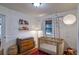 Bright Bedroom featuring a wooden crib, changing table, accent rug, and natural lighting at 2083 W Arbor Ave, Littleton, CO 80120