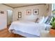 Bright bedroom featuring hardwood floors, neutral walls, a queen bed and natural light from windows at 2083 W Arbor Ave, Littleton, CO 80120