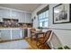 Bright breakfast nook with neutral gray cabinets, wood countertop and wainscoting at 2083 W Arbor Ave, Littleton, CO 80120