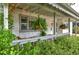 Relaxing front porch with hanging ferns and comfortable seating under ambient string lights at 2083 W Arbor Ave, Littleton, CO 80120