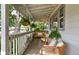 Cozy front porch with a swing, chairs, and hanging ferns, perfect for outdoor enjoyment at 2083 W Arbor Ave, Littleton, CO 80120