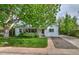 Attractive home features a well-maintained lawn, lush tree, and welcoming front porch at 2083 W Arbor Ave, Littleton, CO 80120