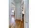 Hallway featuring hardwood floors with doorways leading to other rooms of the home at 2083 W Arbor Ave, Littleton, CO 80120