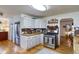 Updated kitchen with wooden countertops, stainless steel appliances, and hardwood floors at 2083 W Arbor Ave, Littleton, CO 80120