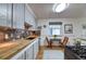 Updated kitchen with wooden countertops, stylish backsplash, and stainless steel appliances at 2083 W Arbor Ave, Littleton, CO 80120