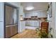 Well lit kitchen with stainless steel appliances, wood countertops, and stylish tile backsplash at 2083 W Arbor Ave, Littleton, CO 80120