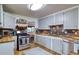 Well lit kitchen with stainless steel appliances, wood countertops, and stylish tile backsplash at 2083 W Arbor Ave, Littleton, CO 80120