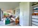 Bright living area featuring natural light, a futon, artistic decor and ample storage at 2083 W Arbor Ave, Littleton, CO 80120