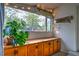 Bright sunroom featuring a built in storage cabinet, natural light and views of the back yard at 2083 W Arbor Ave, Littleton, CO 80120