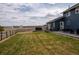 Expansive backyard with a patio, hot tub, and well-maintained lawn at 30484 Chisholm Trl, Elizabeth, CO 80107