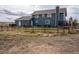 View of the home's backyard featuring the fence, landscaping, and deck with outdoor seating area at 30484 Chisholm Trl, Elizabeth, CO 80107