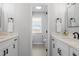 Stylish bathroom with dual vanities, black hardware, and a serene, modern aesthetic at 30484 Chisholm Trl, Elizabeth, CO 80107