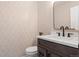 Chic powder room featuring elegant wallpaper, dark vanity, white countertop and black faucet at 30484 Chisholm Trl, Elizabeth, CO 80107