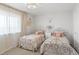 Charming bedroom with two ornate beds, soft lighting, and neutral decor at 30484 Chisholm Trl, Elizabeth, CO 80107