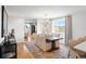 Bright dining room featuring hardwood floors, modern chandelier, neutral paint and large windows with field views at 30484 Chisholm Trl, Elizabeth, CO 80107