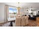 Elegant dining room with a rustic table, chandelier, and views of the outdoors at 30484 Chisholm Trl, Elizabeth, CO 80107