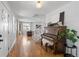 Bright and airy foyer featuring hardwood floors, a staircase, and a vintage piano at 30484 Chisholm Trl, Elizabeth, CO 80107