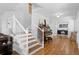 Elegant foyer with a staircase, gleaming hardwood floors, and natural light at 30484 Chisholm Trl, Elizabeth, CO 80107