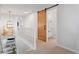 Upstairs hallway featuring a barn door and views to the lower level at 30484 Chisholm Trl, Elizabeth, CO 80107